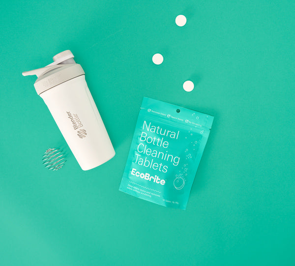 A bag of EcoBrite cleaning tablets next to a white shaker, emphasizing health and wellness products.