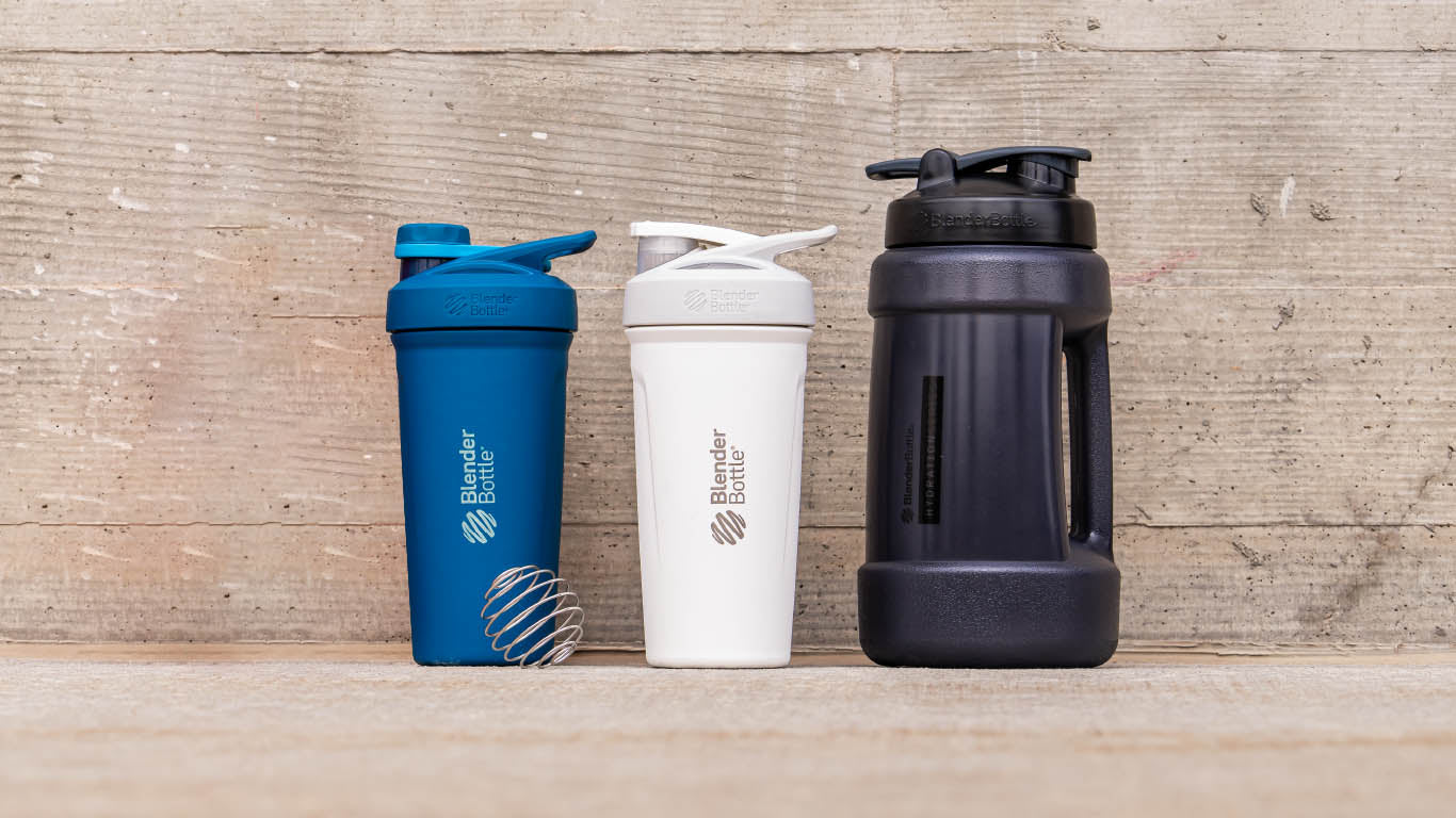 A group of BlenderBottle cups including a black Koda 2.2 liter jug and stainless shaker cups.