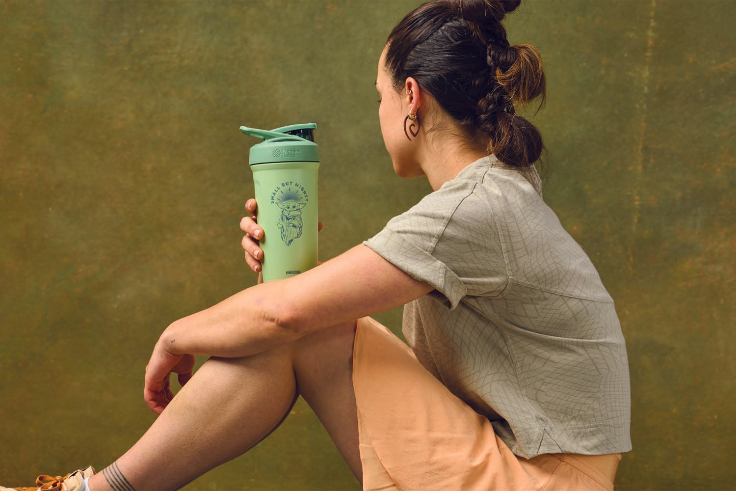 Woman holding Grogu BlenderBottle shaker cup