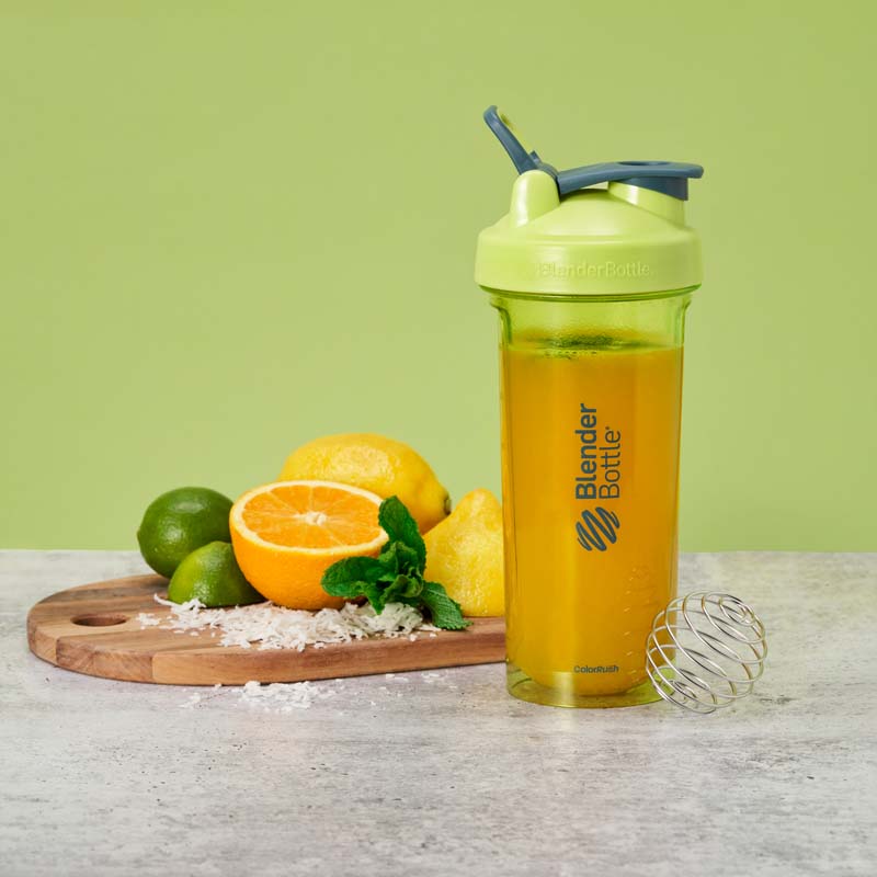 Green Electric Serenity shaker bottle with sliced citrus and coconut flakes.