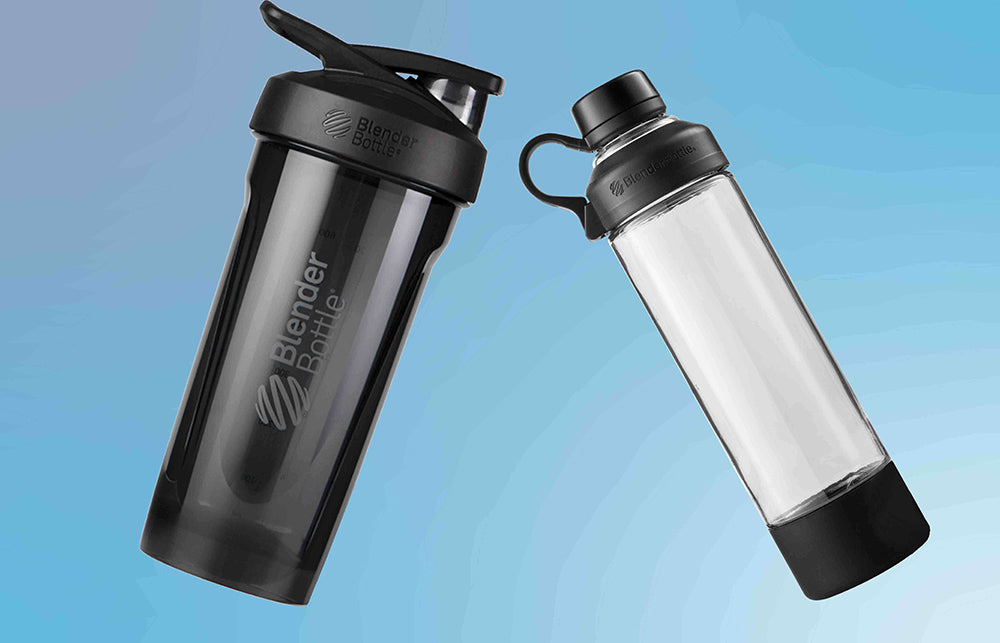Close-up of a black shaker bottle and glass shaker with a black lid, emphasizing their sleek, cylindrical design.