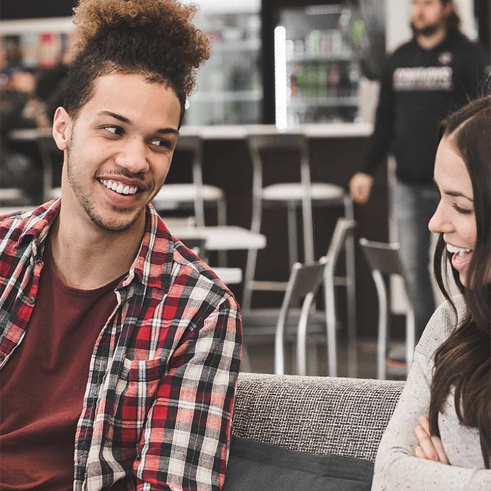 Two BlenderBottle employees smiling and talking