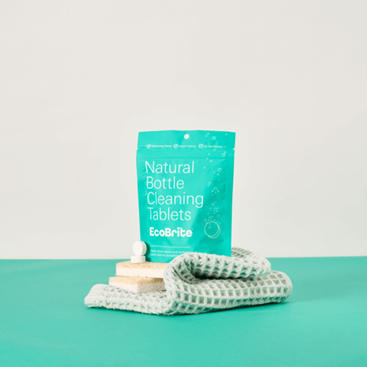EcoBrite Cleaning Tablet Package sits on sponges and cleaning towel