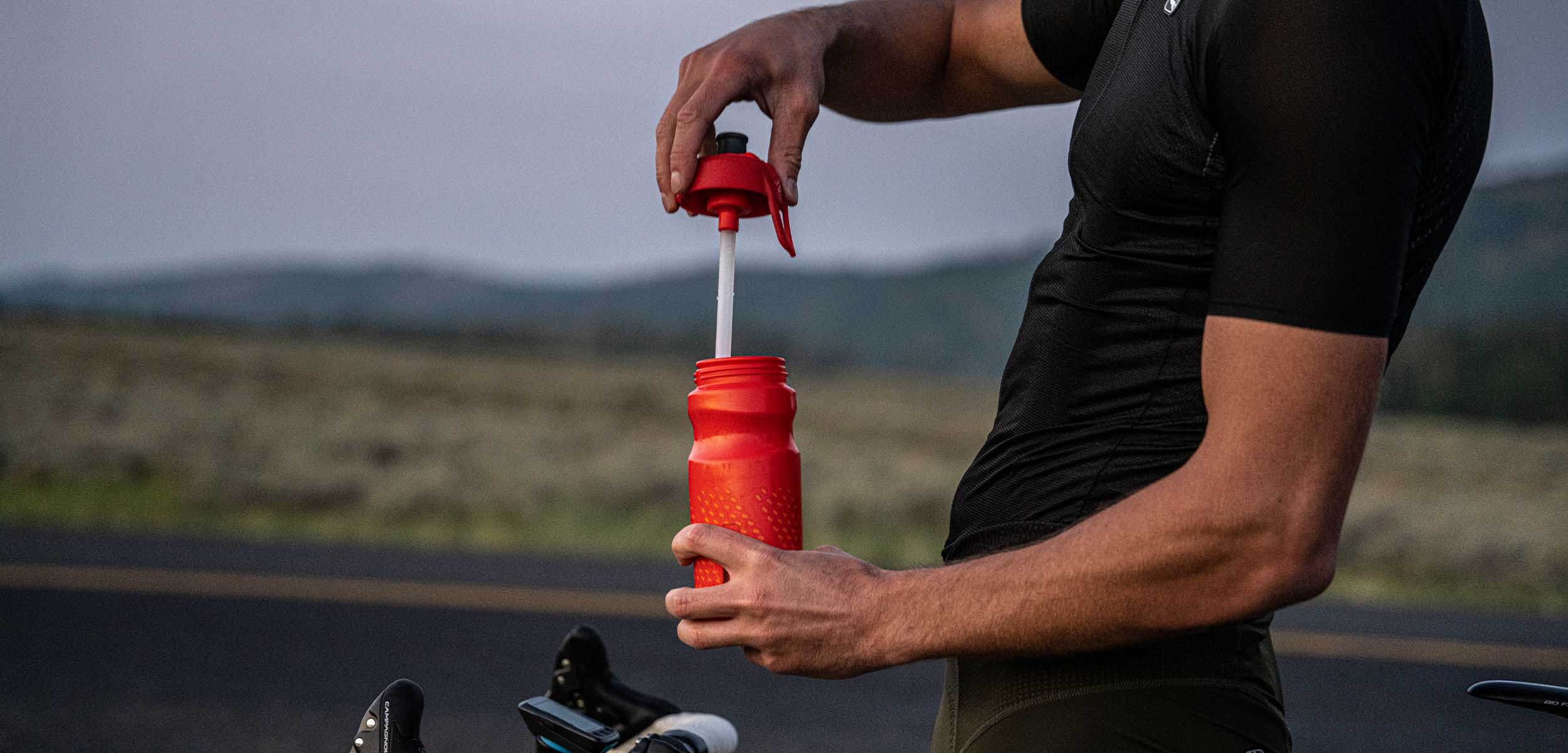 Man opening a BlenderBottle Halex sports squeeze drinking bottle