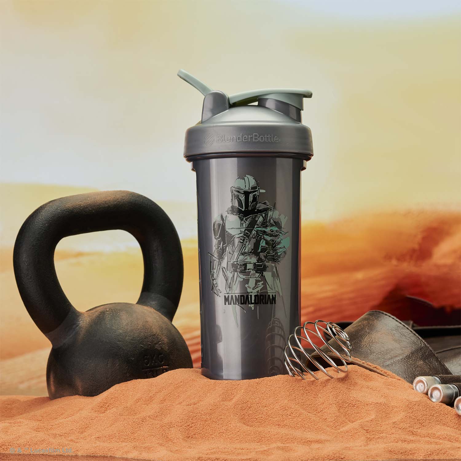 Mandalorian protein shaker cup in a desert setting with a kettlebell and wire whisk BlenderBall