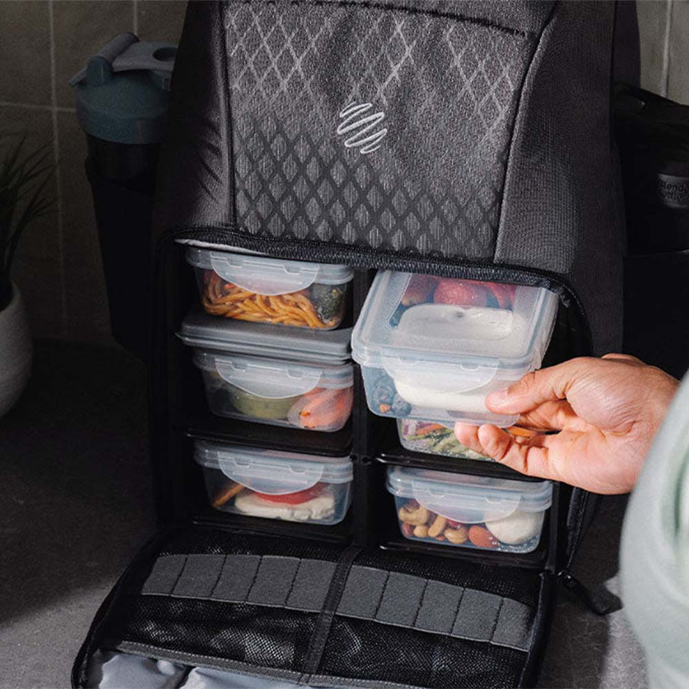 Person putting meals in a 6 meal backpack