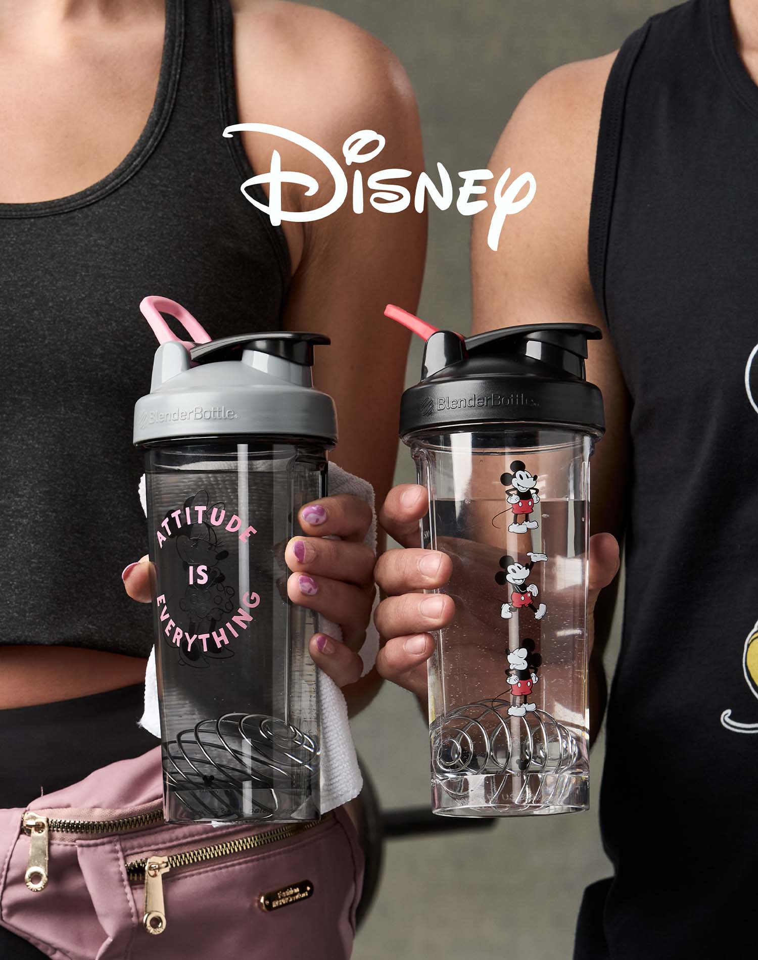 Man and woman holding Mickey and Minnie protein shaker cups