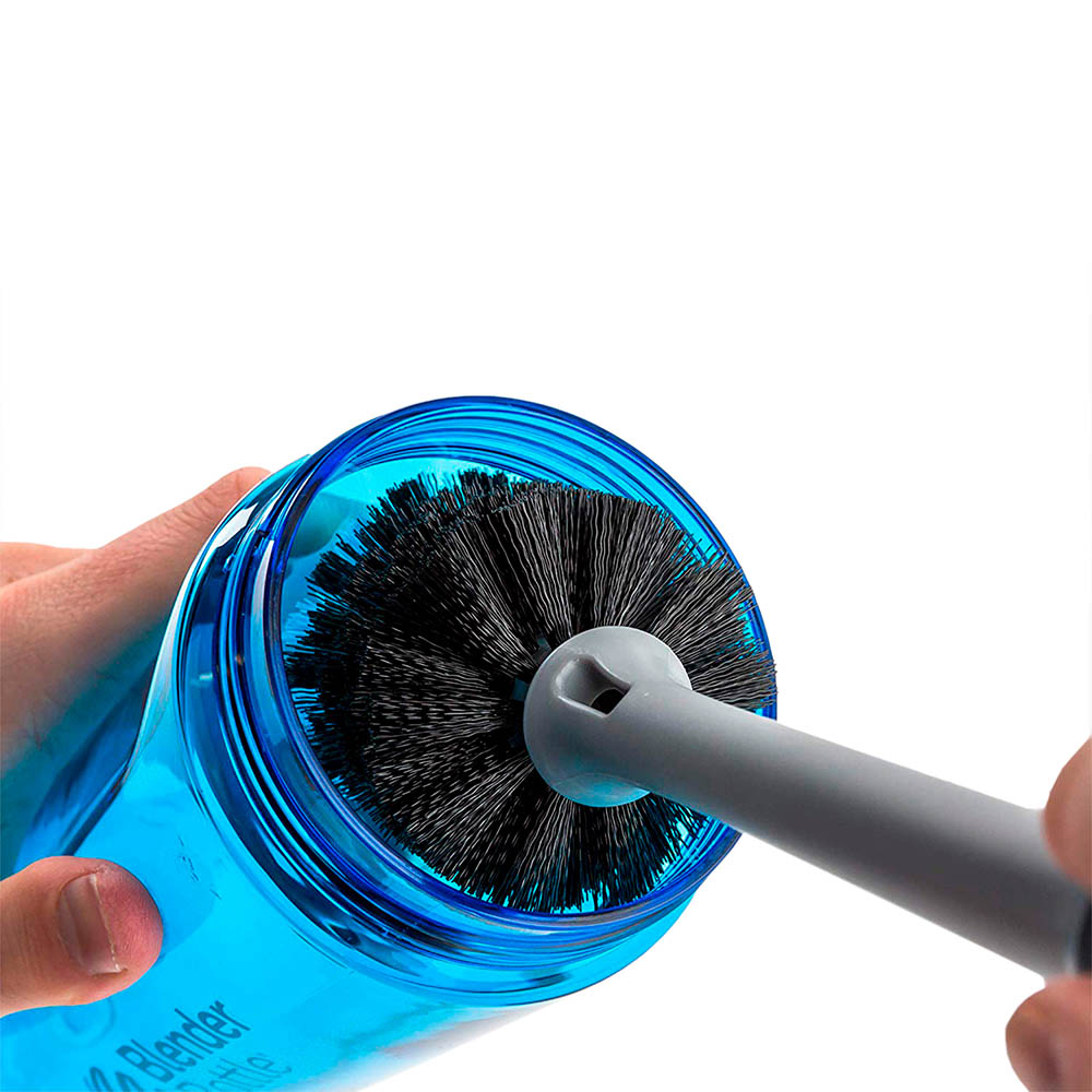 Person cleaning a shaker bottle with a Blender Bottle brush