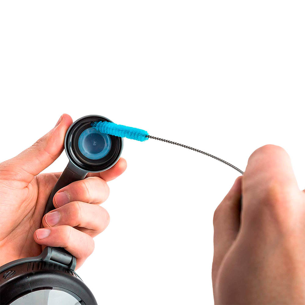 Person cleaning a shaker bottle lid with the bottle brush mini straw brush