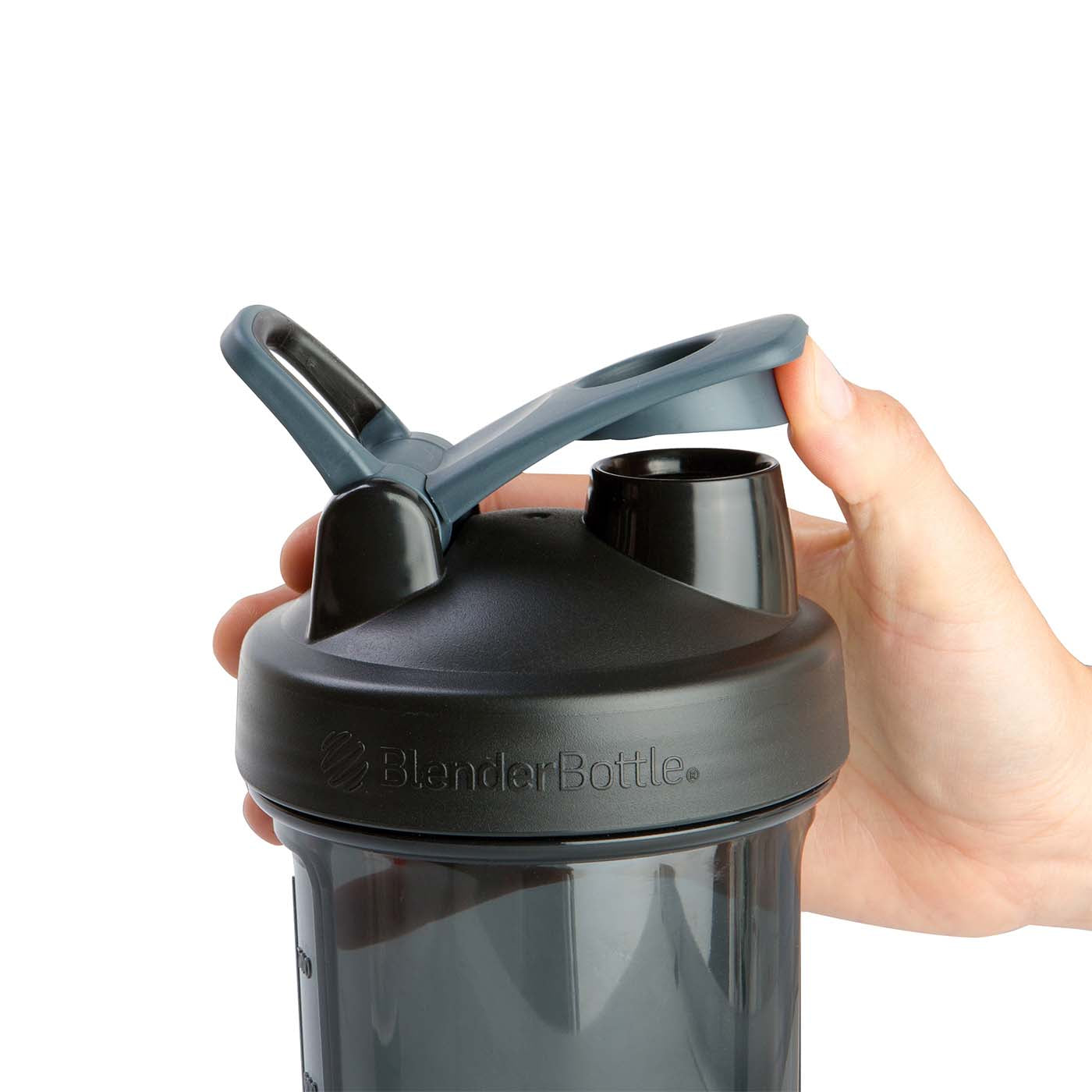 Hand holding a BlenderBottle with a SpoutGuard cap, which snaps closed to keep the drinking spout clean.