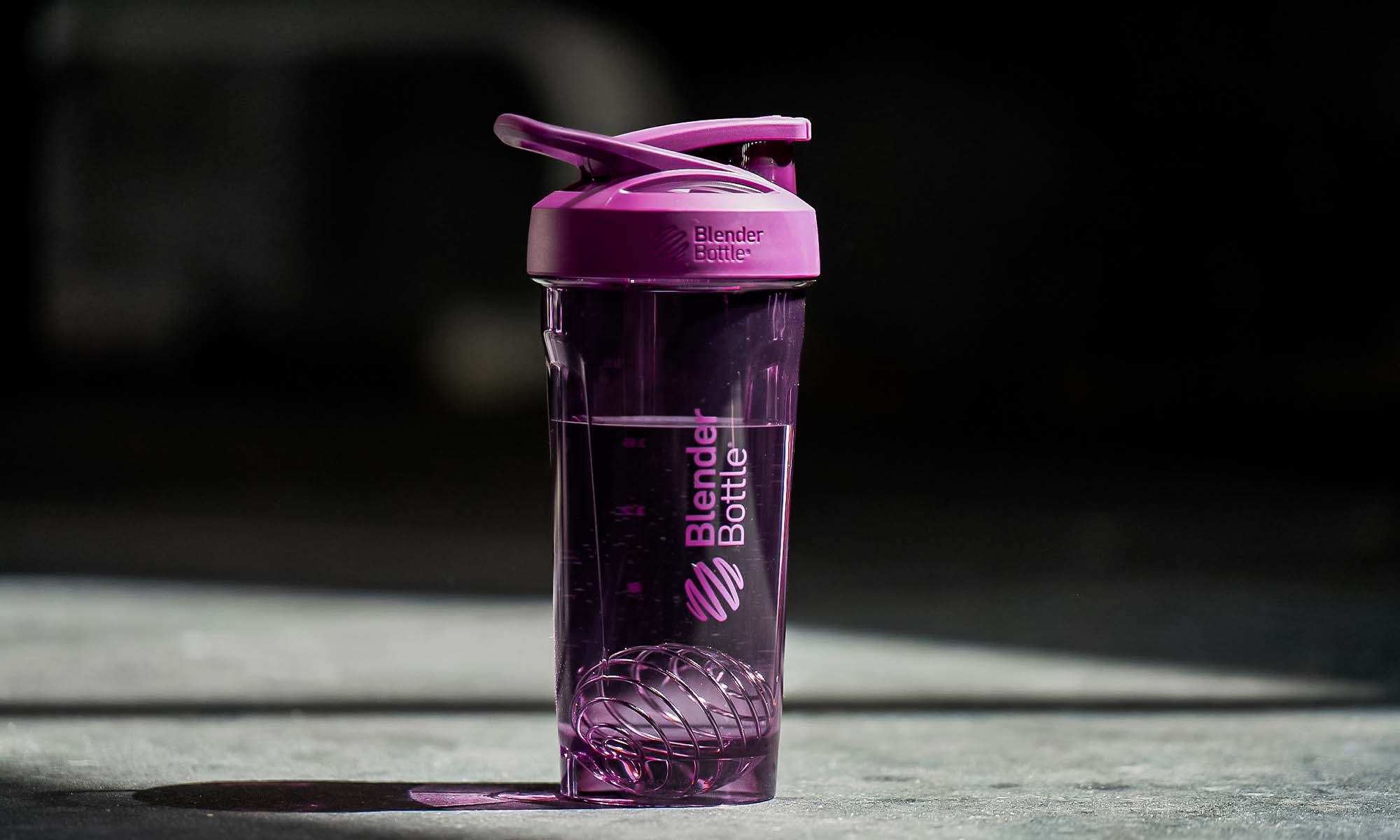 A BlenderBottle Strada shaker cup with lockable lid in the gym