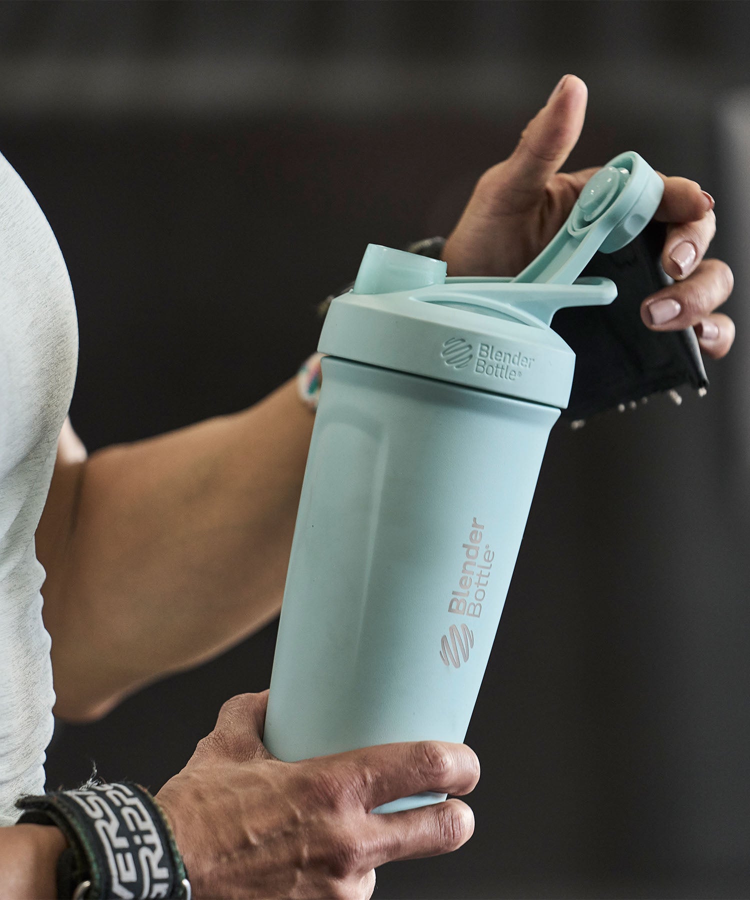 Woman holding an light blue insulated stainless steel shaker bottle