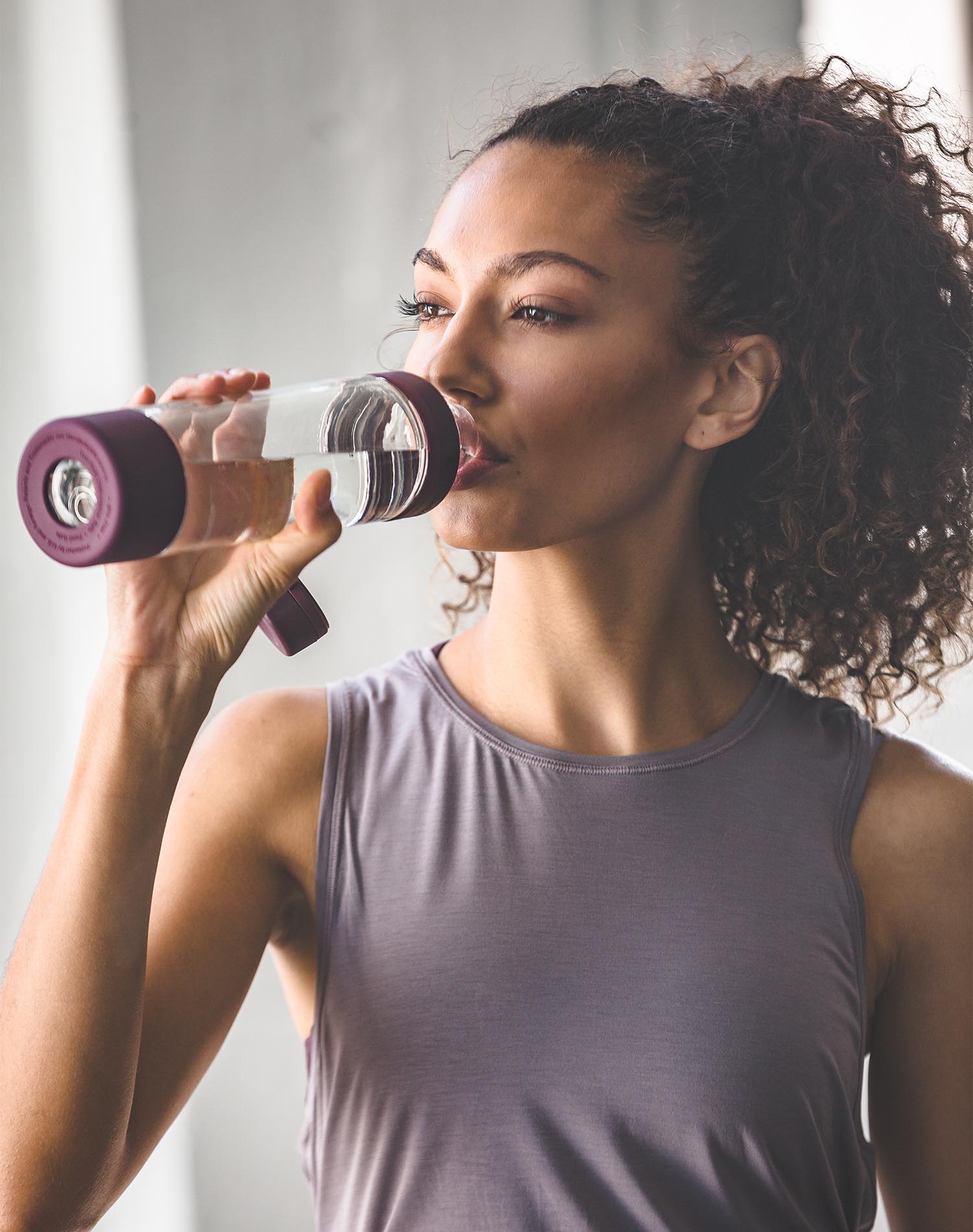 Woman drinking from glass Mantra BlenderBottle shaker cup