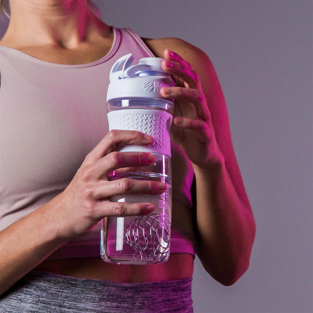 Woman holding a SportMixer shaker bottle, water bottle hybrid